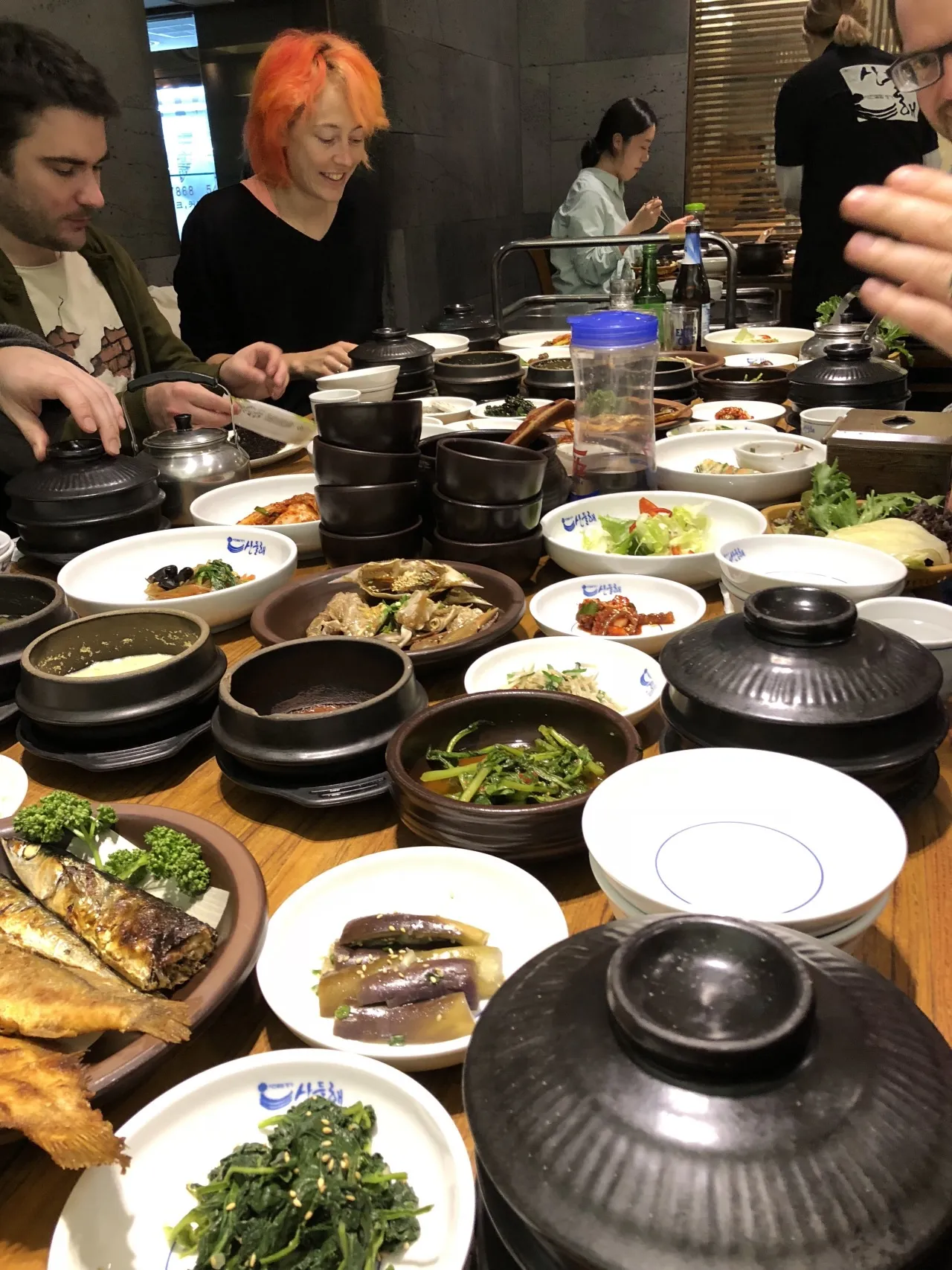 A restaurant table crowded with dishes