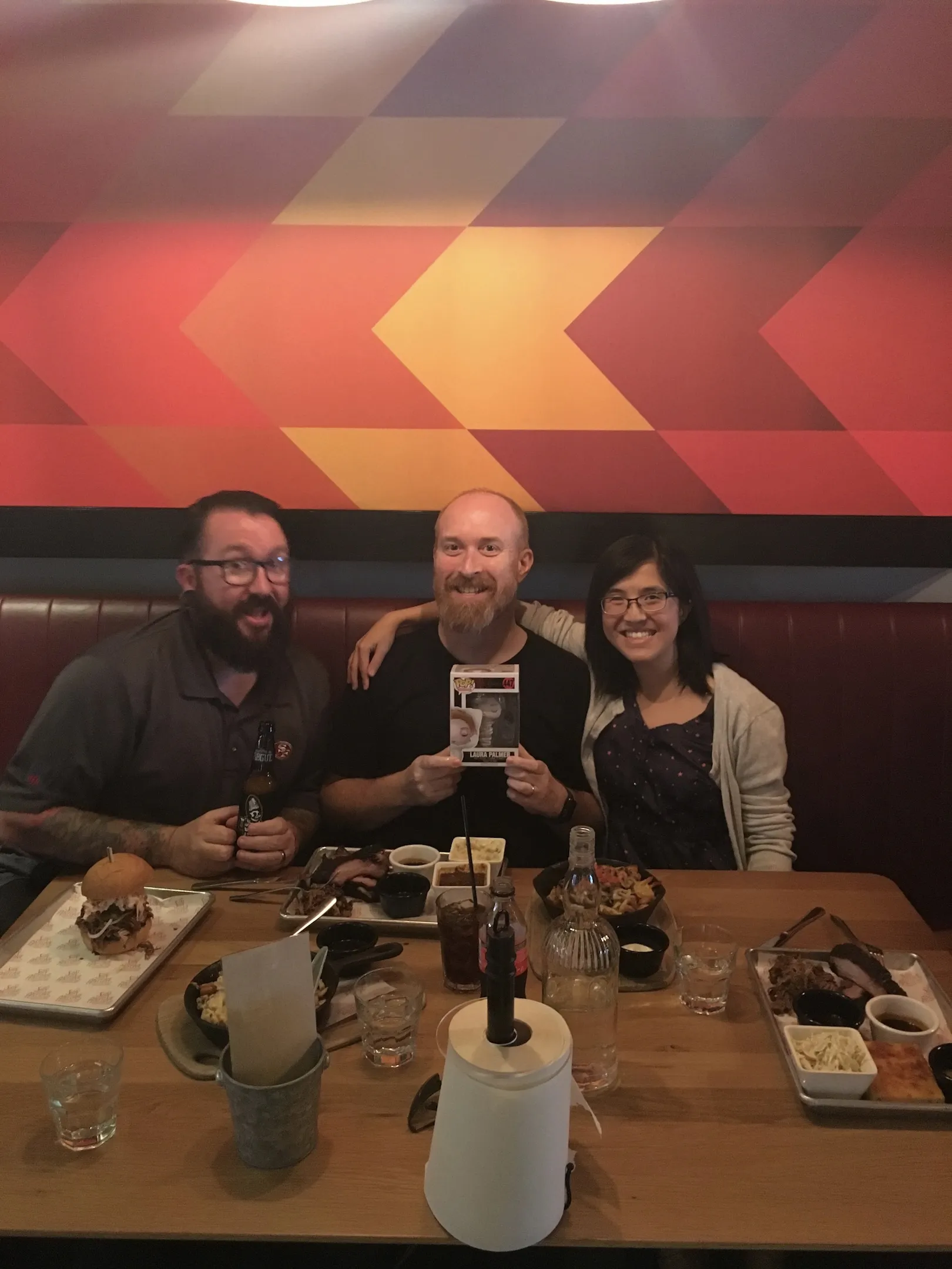 Three people around a restaurant table