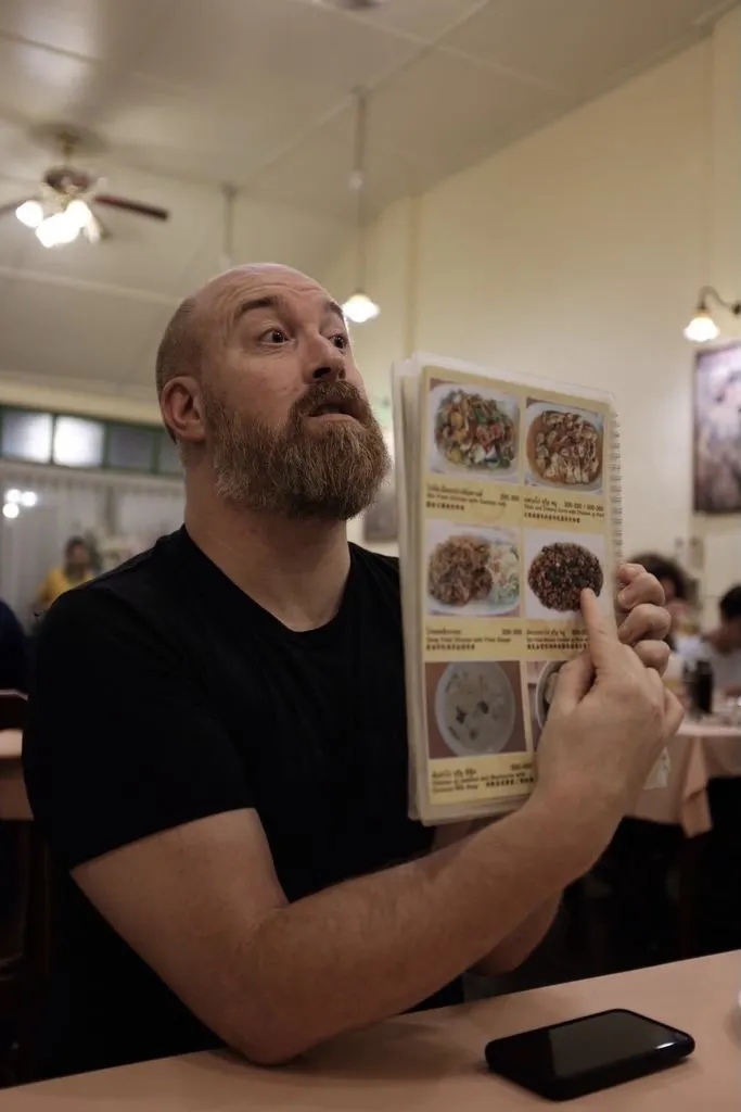 A man pointing to a menu