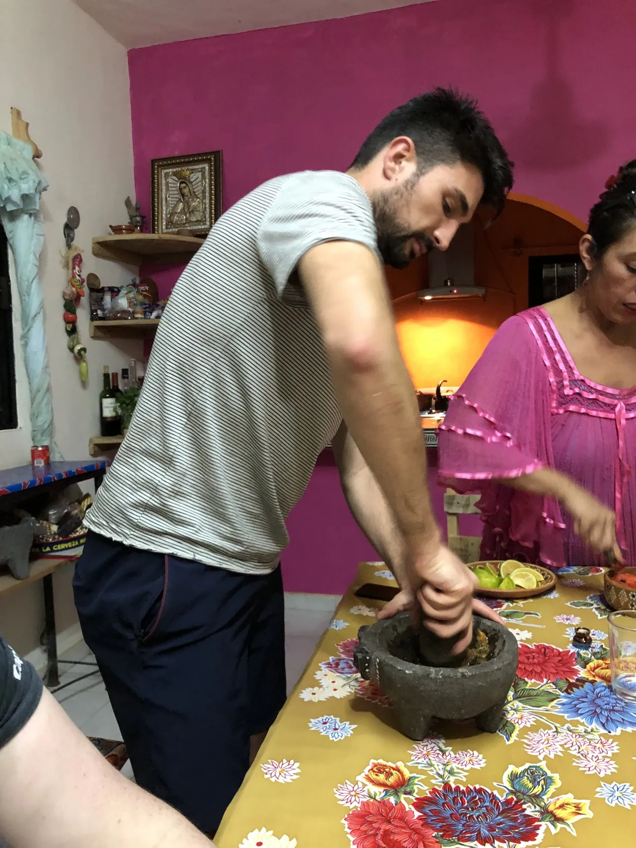 A man using a mortar and pestle