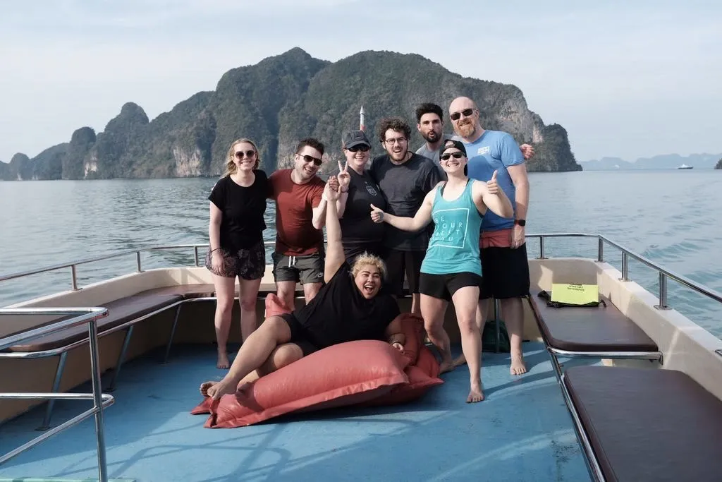 People posing on a sailboat