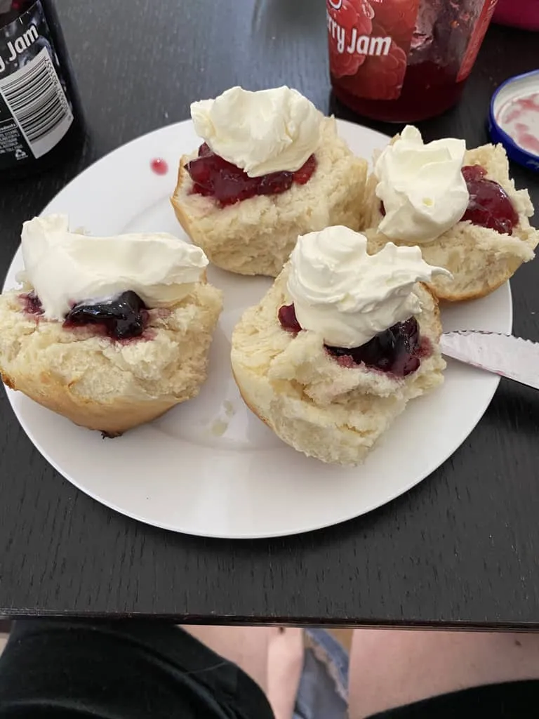 Scones with cream on top of jam