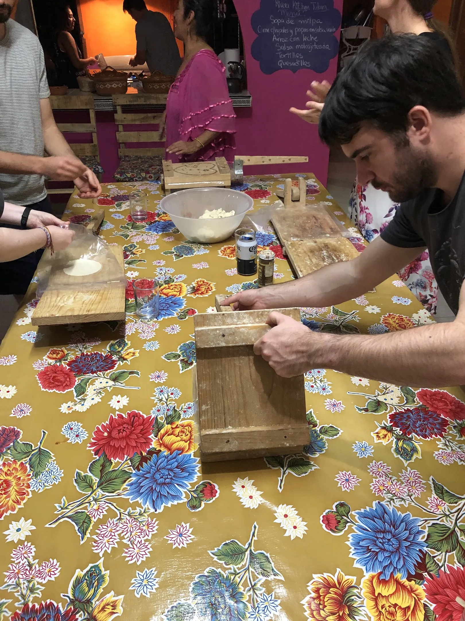 A man using a tortilla press