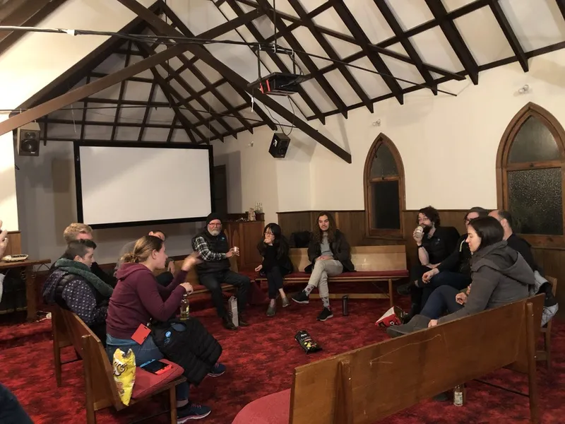 People gathered in a converted chapel